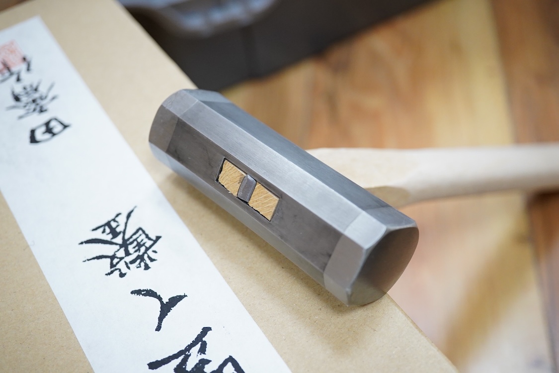 A collection of Japanese woodworking chisels and hammers, including; three boxed large mortise chisels, three boxed timber framing chisels (largest 90mm), and five heavy duty hammers/mallets (11)